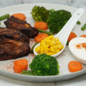 a white plate topped with meat and veggies